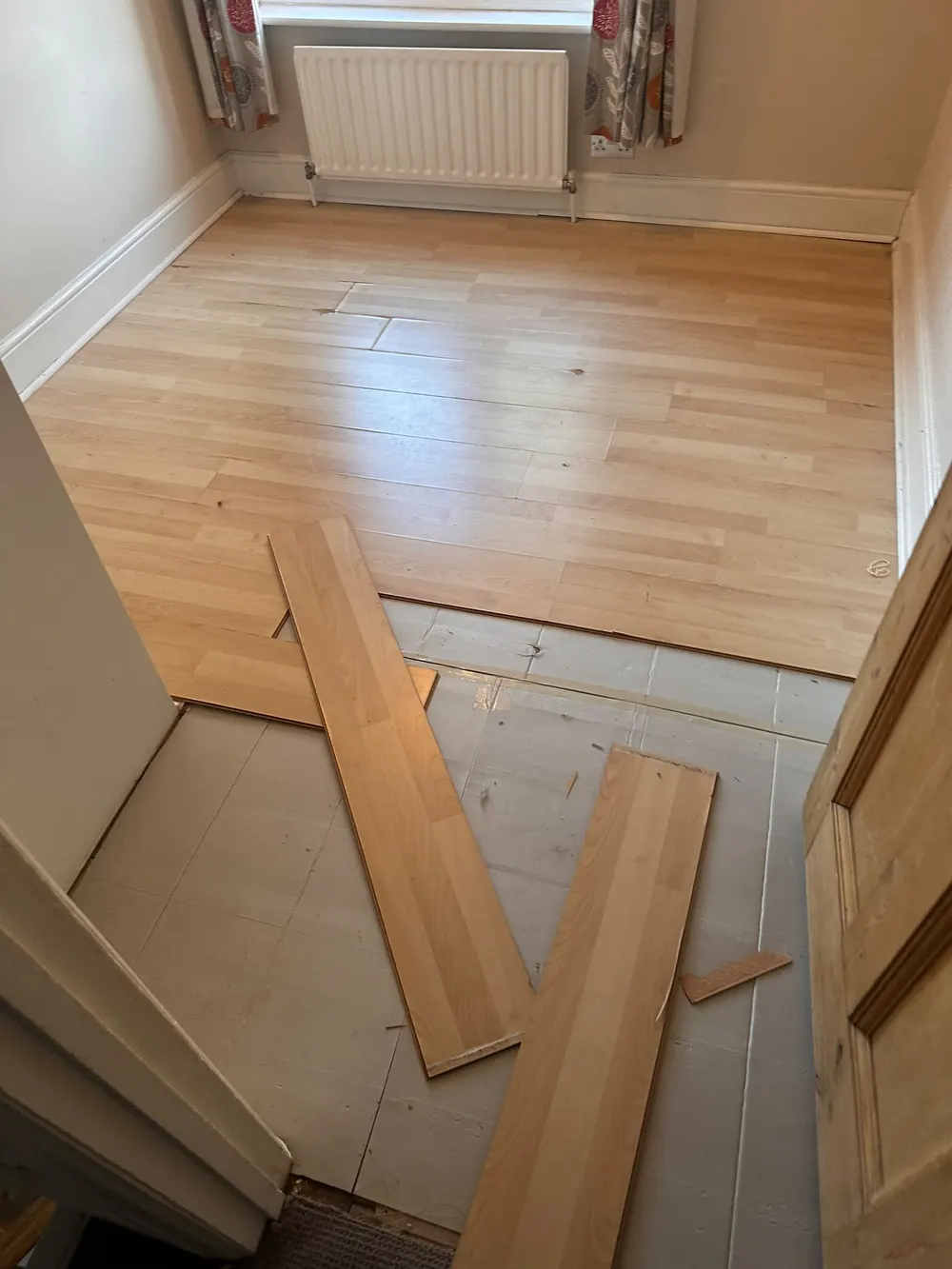 Second bedroom with laminate panels carefully lifted around the painted scotia before carpet fitting — South Croydon