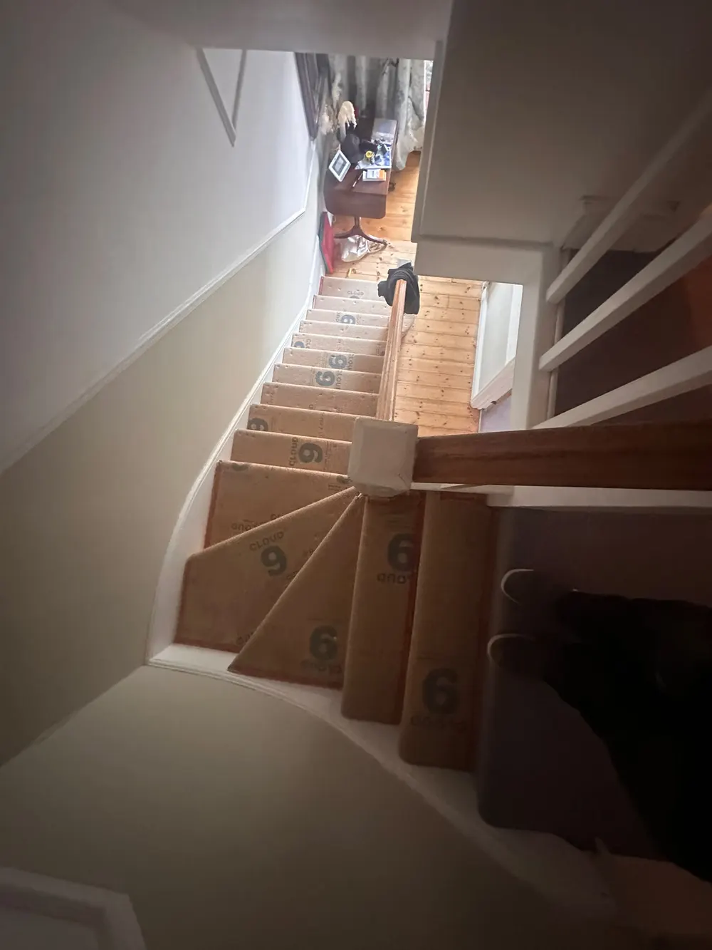 Staircase with new Cloud 9 underlay laid on the treads and winders, ready for carpet — South Croydon