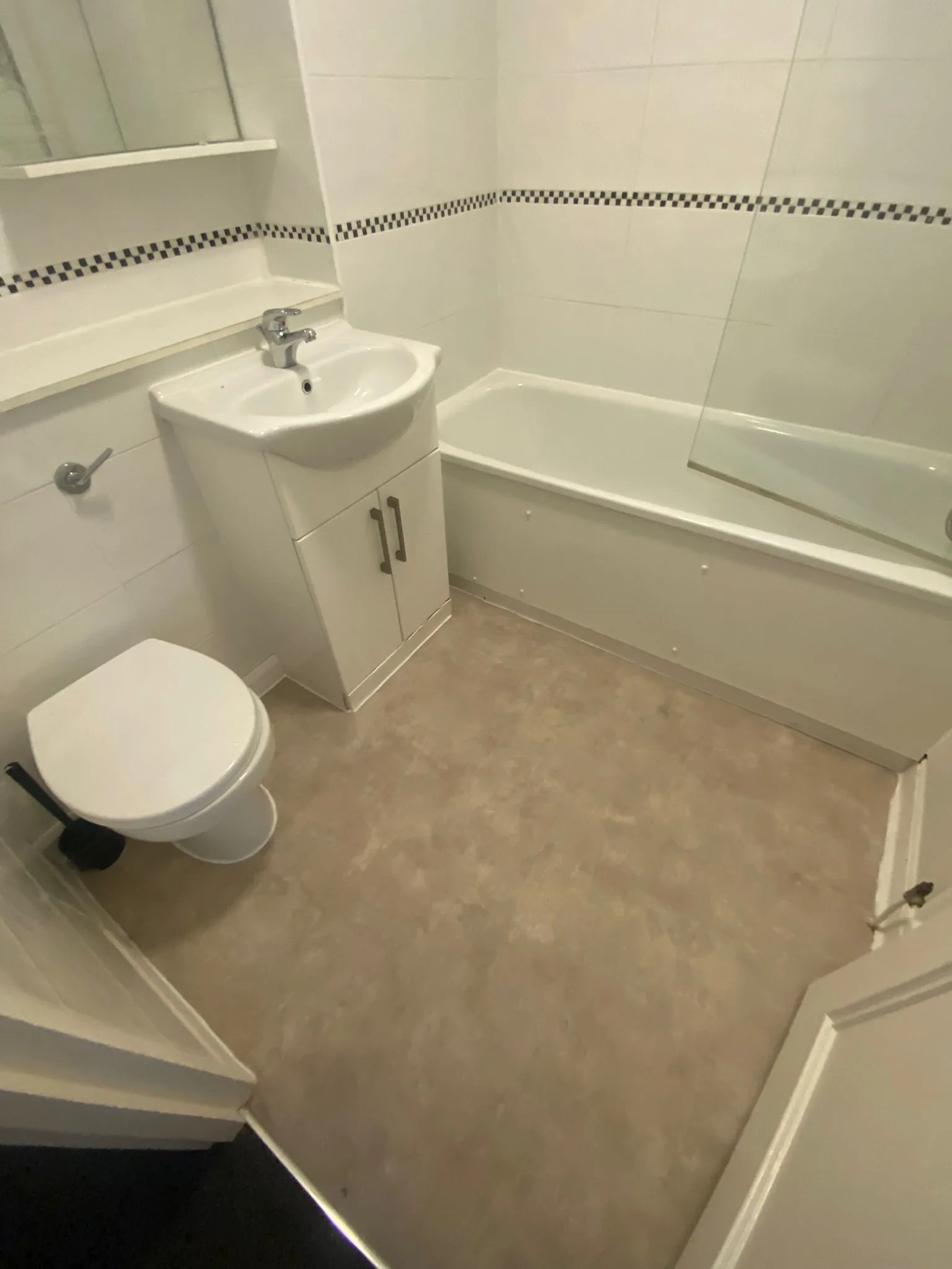 Grey stone-effect sheet vinyl flooring fitted in a modern residential bathroom